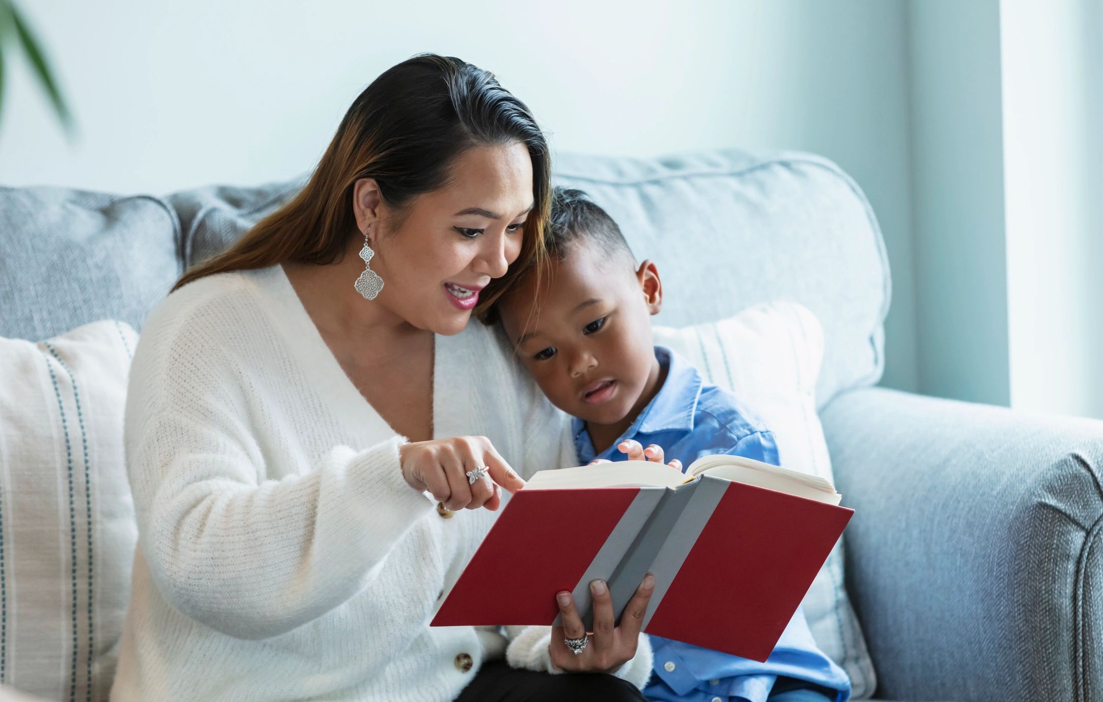 Caregiver and child reading together