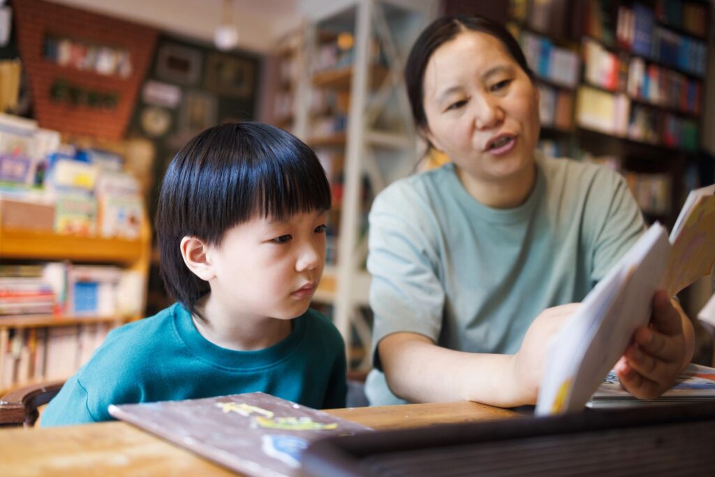 Mom and her son are reading at a bookstore